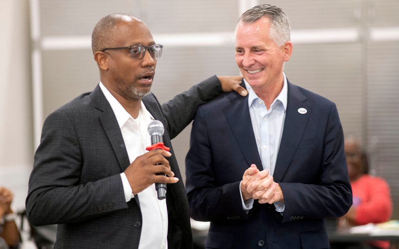 Escambia County Commissioner Lumon May helps drum up support for gubernatorial candidate David Jolly at the Brownsville Library on March 10, 2026. Jolly was visiting Pensacola and Northwest Florida as part of a campaign swing through the state.