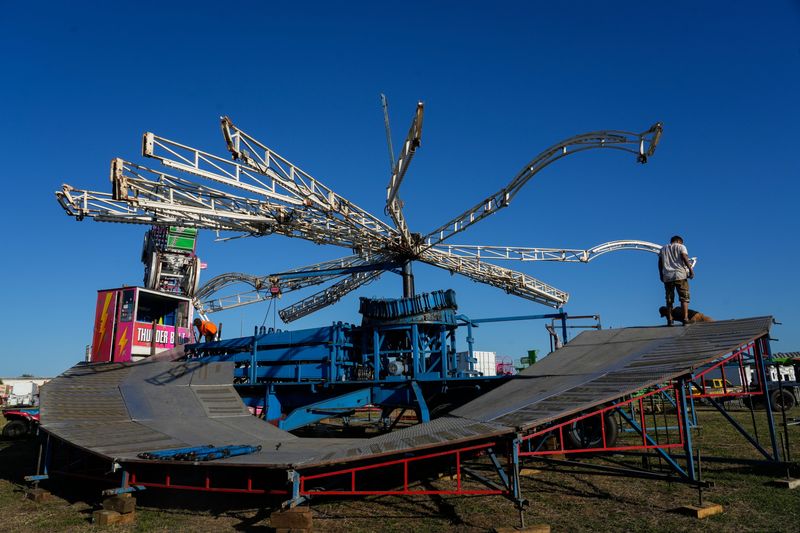 Preparations are underway March 10, 2026, at the Indian River County fairgrounds on 58th Avenue between 77th and 81st streets, as crews assemble rides and vendors clean off their gear ahead of the Firefighters’ Fair. The fair includes youth livestock and horticulture activities, firefighter training shows, an interactive reptile show and alligator wrestling, Paul Bunyan Lumberjack Show, and The Bellamy Brothers concert on March 14. It opens daily starting 5 p.m. March 13 and closes 10 p.m. March 22. For more information, including tickets and parking, visit www.firefightersfair.org.