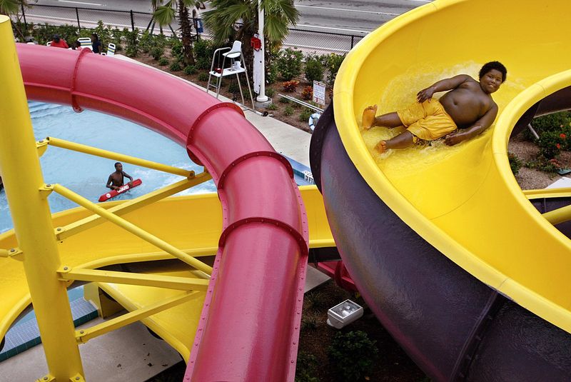 A.J. Stephens, 10, of Riviera Beach, zips down one of two waterslides at the newly opened Barracuda Bay Family Water Park in 2003 at 1621 Blue Heron Blvd. Greg Lovett/Palm Beach Post