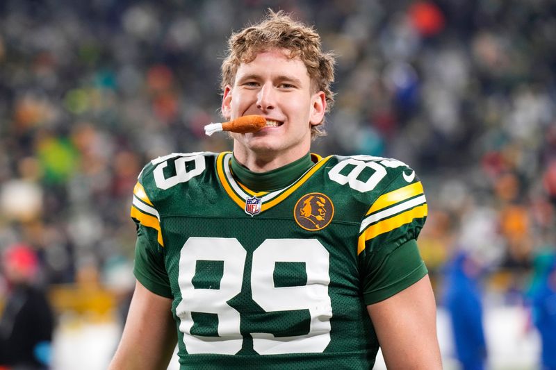 ``Nov 28, 2024; Green Bay, Wisconsin, USA; Green Bay Packers tight end Ben Sims (89) bites a fake turkey leg following the game against the Miami Dolphins at Lambeau Field. Mandatory Credit: Jeff Hanisch-Imagn Images