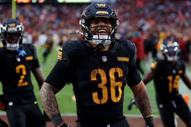 Dec 1, 2024; Landover, Maryland, USA; Washington Commanders running back Chris Rodriguez Jr. (36) celebrates after scoring a touchdown against the Tennessee Titans during the fourth quarter at Northwest Stadium. Mandatory Credit: Geoff Burke-Imagn Images