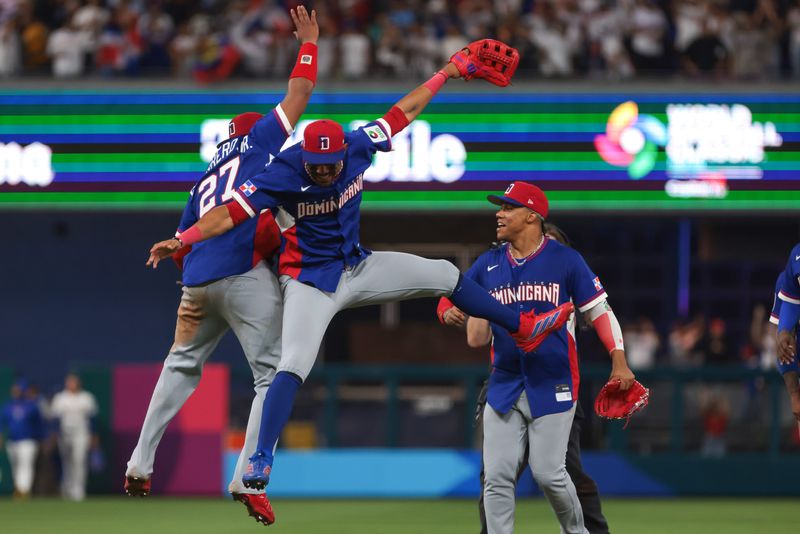 Mar 11, 2026; Miami, FL, United States; Dominican Republic center fielder Julio Rodriguez (44) celebrates with first baseman Vladimir Guerrero Jr. (27) and left fielder Juan Soto (22) after the game against Venezuela at loanDepot Park. Mandatory Credit: Sam Navarro-Imagn Images