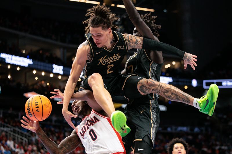 Mar 12, 2026; Kansas City, MO, USA; UCF Knights guard Riley Kugel (2) leaps over Arizona Wildcats guard Jaden Bradley (0) during the first half at T-Mobile Center. Mandatory Credit: William Purnell-Imagn Images