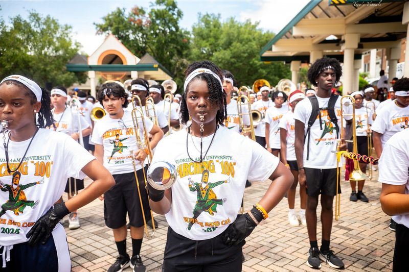 Drum majors and trombone players stand tall and focused as the Marching “100” gears up for their summer showcase performance during the 2025 FAMU Summer Band Camp.