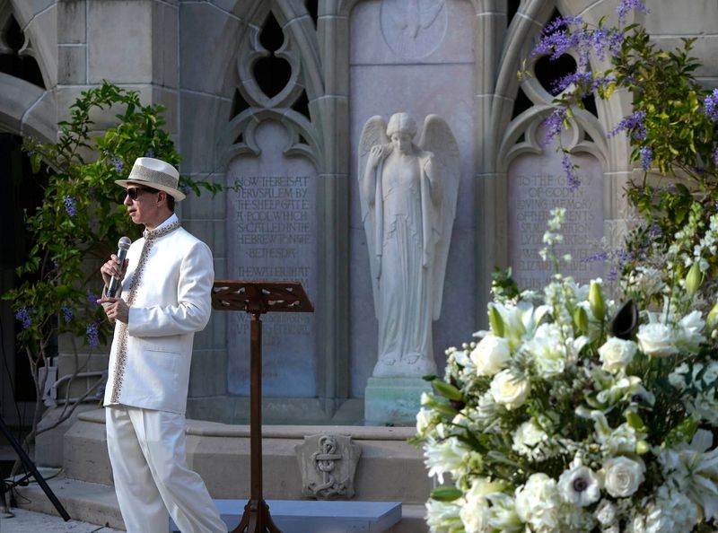 Modeling a Mandarin-style brocade suit, The Rev. Tim Schenck welcomes guests to the St. Mary’s Guild and the Church Mouse third annual Fashion Show Fundraiser at The Church of Bethesda-By-The-Sea on March 10.