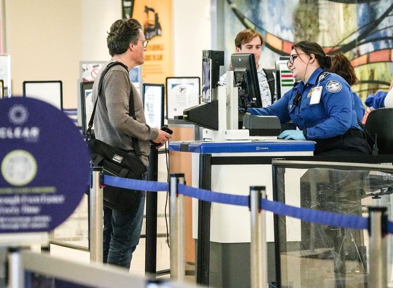 Transportation Security Administration (TSA) workers check over carry-on items at Greenville-Spartanburg International Airport in Greer, SC Friday, March 13, 2026. The workers are doing their job without getting paid until after the partial Federal Governenment Shutdown is resolved.