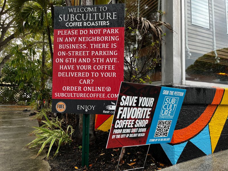 Signs posted at the Subculture Coffee Roasters shop in Delray Beach speak to a dispute between the company and the city of Delray Beach on its number of parking spaces.