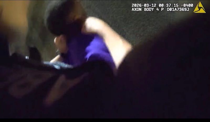 A screen shot from a Daytona Beach police body camera video shows an officer punching a man who was on the ground beneath the officer.