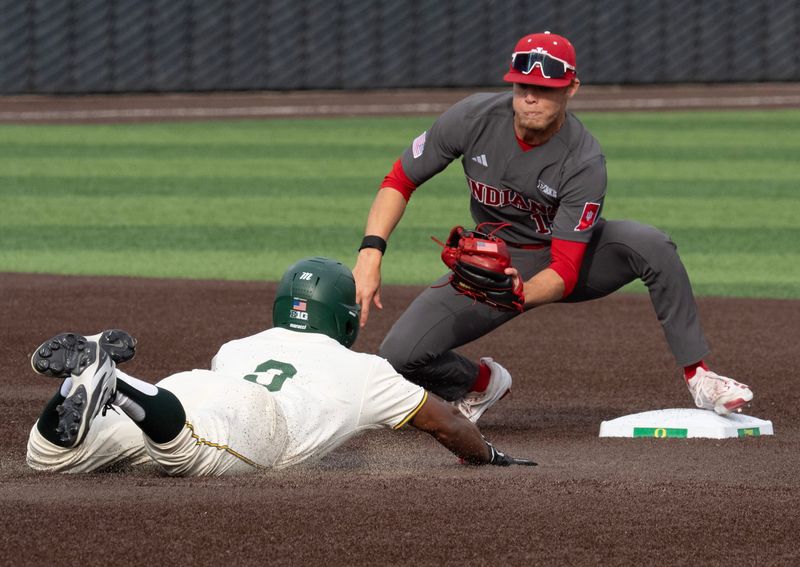 Oregon’s Elijah Cook, left, is caught trying to steal second by Indiana’s Cooper Malamazian during the third inning at PK Park in Eugene March 13, 2026.