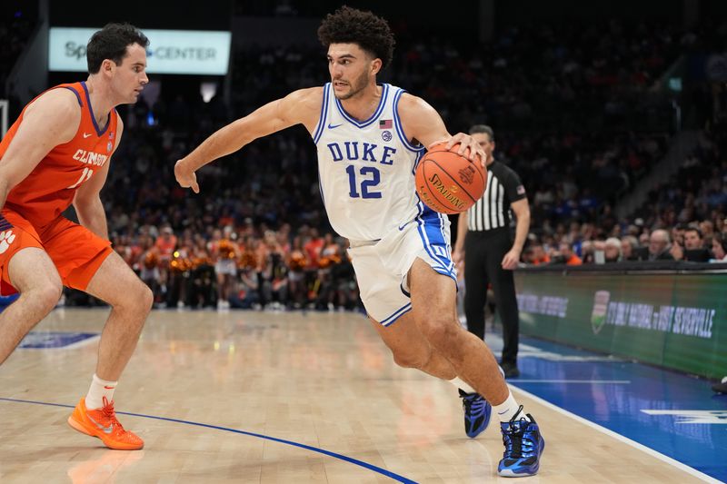 Duke Blue Devils forward Cameron Boozer (12) with the ball as Clemson Tigers forward Nick Davidson (11) defends in the second half at Spectrum Center in Charlotte, NC.