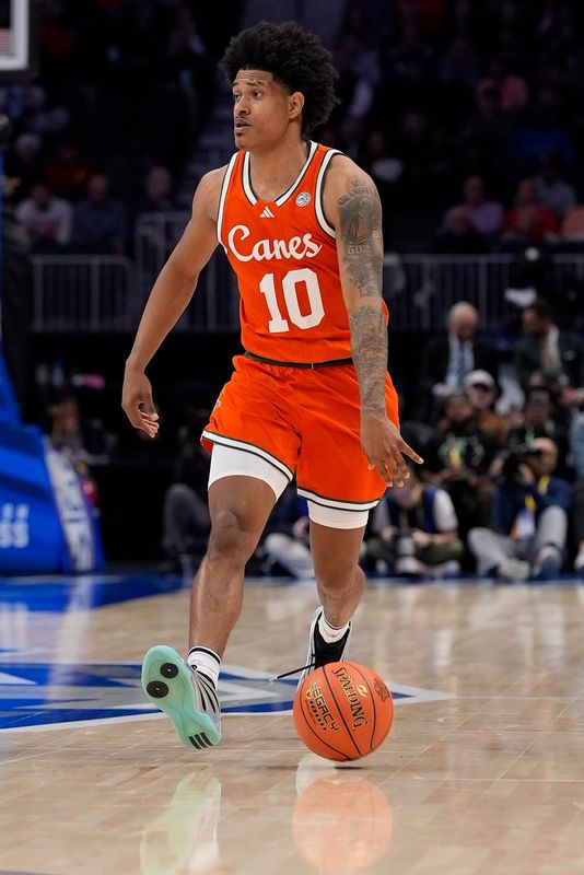 Miami Hurricanes guard Tru Washington (10) brings the ball up court during the second half against the Virginia Cavaliers in the ACC tournament semifinals March 13, 2026 at Spectrum Center in Charlotte, NC. Mandatory Credit: Jim Dedmon-Imagn Images