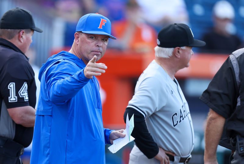 Florida head coach Kevin O'Sullivan meets with South Carolina head coach Paul Mainieri before an NCAA baseball game at Condron Ballpark in Gainesville, FL on Friday, March 13, 2026. [Alan Youngblood/Gainesville Sun]
