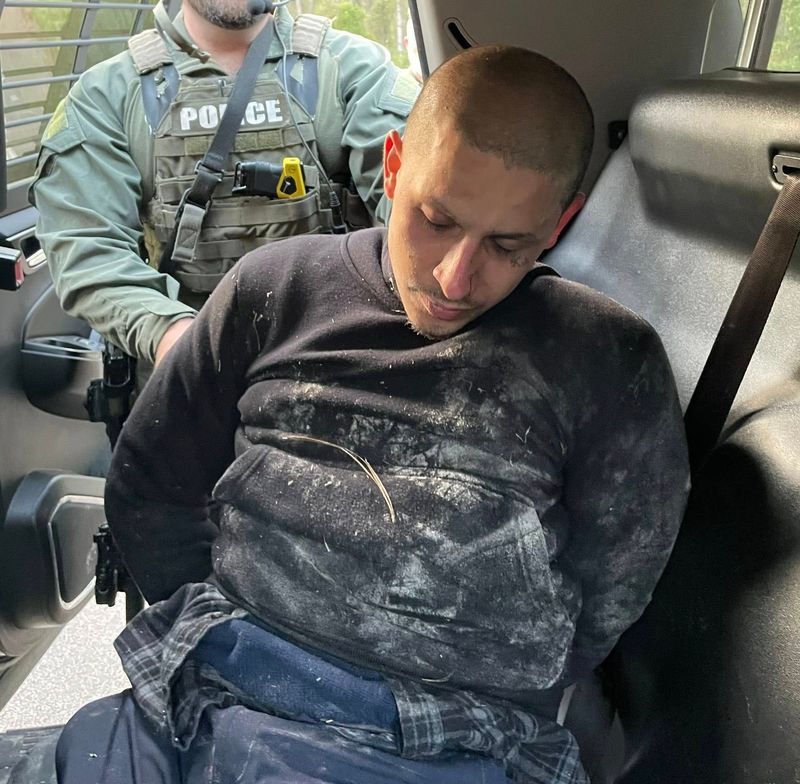 Authorities take Christian Joseph Barrios into custody following vehicle pursuit, crash and then search in some woods off County Road 108 in Nassau County early on March 14. He was wanted in a shooting late the prior night that killed two people he knew outside a Walgreens near The Players Championship in Ponte Vedra Beach.