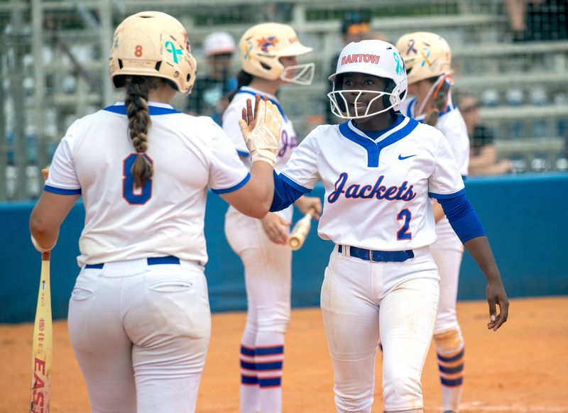 Bartow's Niamah Johnson is congratulated by Alyssa Hillman after scoring against Plant City on Saturday in the championship game of the 2026 Home of Champions Softball Tournament at Bartow High School.