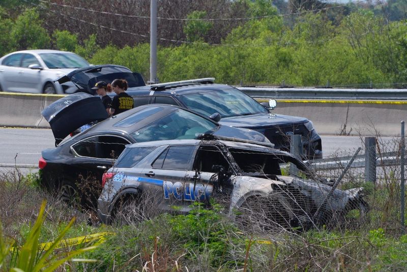 A severely damaged South Daytona Police SUV sits on the side of I-95 north by the Daytona Beach Racing and Card Club around 11:30 a.m. March 15, 2026, after a fleeing suspect crashed and opened fired on police, officials said. An officer was struck and transported to the hospital.