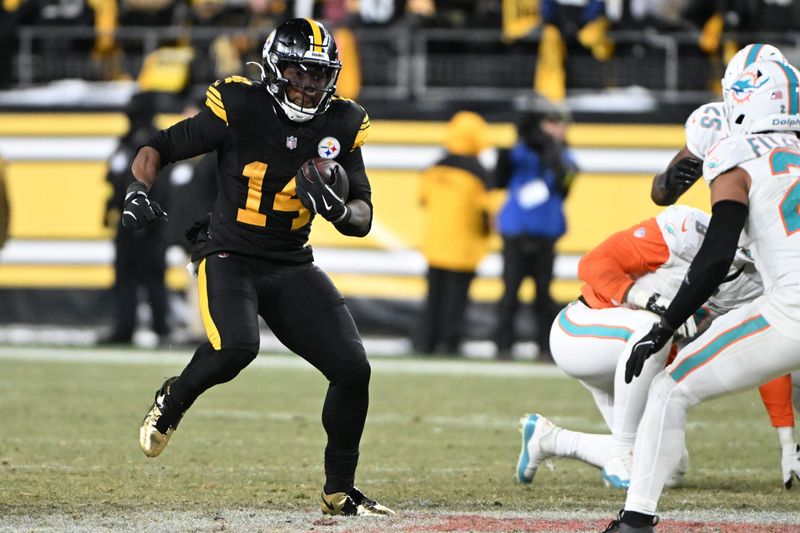Dec 15, 2025; Pittsburgh, Pennsylvania, USA; Pittsburgh Steelers running back Kenneth Gainwell (14) runs during the third quarter against the Miami Dolphins at Acrisure Stadium. Mandatory Credit: Barry Reeger-Imagn Images