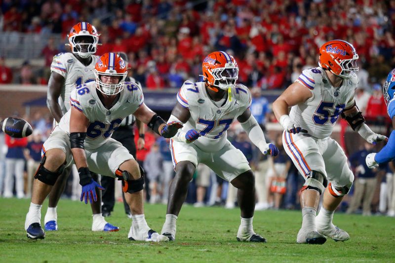 Nov 15, 2025; Oxford, Mississippi, USA; Florida Gators offensive linemen Jake Slaughter (66), Knijeah Harris (77) and Austin Barber (58) block during the second quarter against the Mississippi Rebels at Vaught-Hemingway Stadium. Mandatory Credit: Petre Thomas-Imagn Images