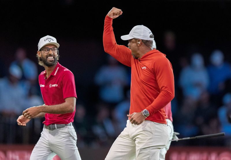 Tiger Woods, right, and Akshay Bhatia of Jupiter Links GC
celebrate their win over Boston Common Golf during TGL match at SoFi Center on March 17, 2026, in Palm Beach Gardens, Florida.