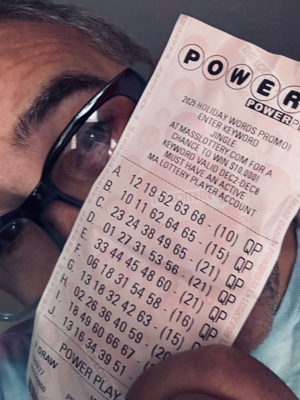 A hopeful patron with a Powerball ticket before a past drawing.