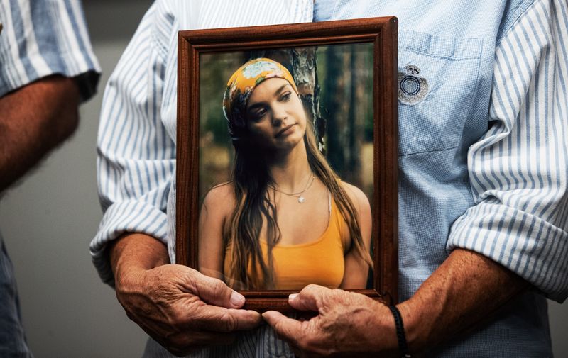 Family members of Julia Curvo display photos of her during a press conference regarding her homicide investigation on Thursday, March 19, 2026.