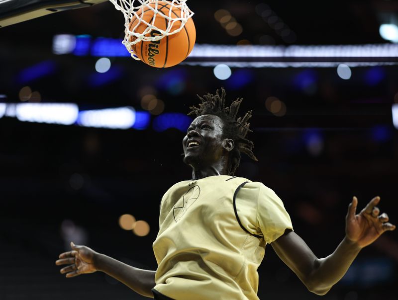 Mar 19, 2026; Philadelphia, PA, USA; UCF Knights center John Bol (7) dunks the ball during a practice session ahead of the first round of the men's 2026 NCAA Tournament at Xfinity Mobile Arena. Mandatory Credit: Bill Streicher-Imagn Images