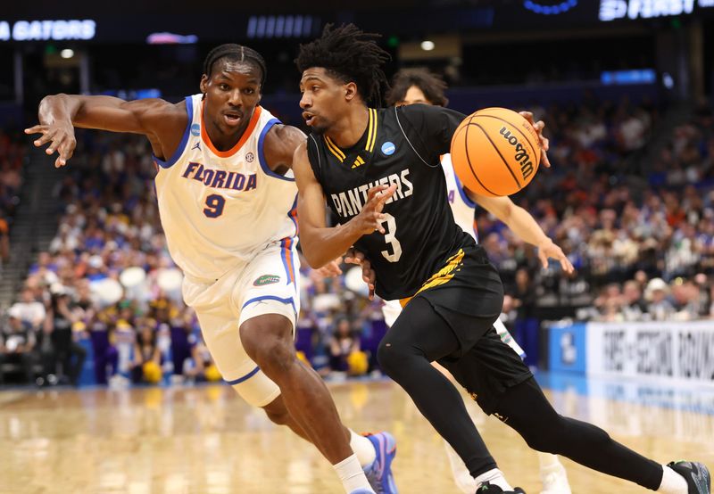 Florida center Rueben Chinyelu (9) pressures Prairie View A&M guard Tai'reon Joseph (3) during the NCAA March Madness opening round at Benchmark international Arena in Tampa, FL on Friday, March 20, 2026. [Alan Youngblood/Gainesville Sun]
