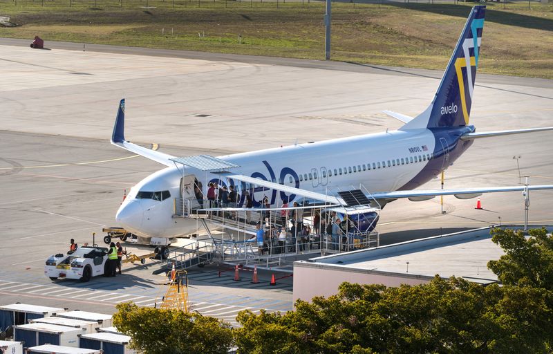 Passengers board an Avelo Airline jet at Palm Beach International Airport on March 11, 2026, in West Palm Beach, Florida.