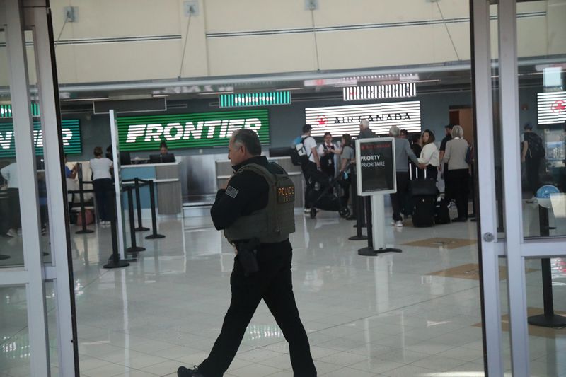 Members of Immigration and Customs Enforcement are seen at Southwest Florida International Airport onMonday, March 23, 2026. They are helping with TSA staff shortages.