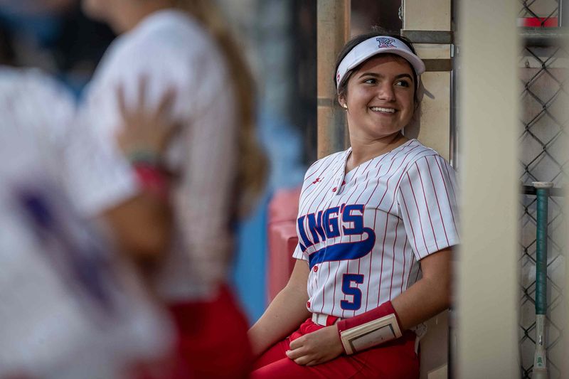 Natalie Velazco (5) talks with teammates in the dugout as The King's Academy Lions hosted the Cardinal Newman High School Crusaders in Florida High School Athletic Association girls' varsity softball at their campus in unincorporated Palm Beach County, Fla., on March 23, 2026. The Lions won 19-3 in four innings.