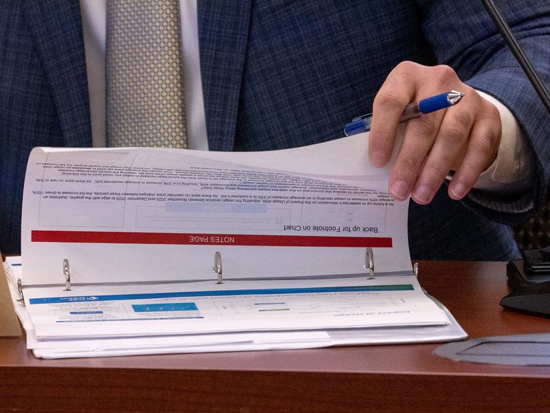 A Duke Energy Indiana represnetative looks through their presentation as the IURC questions large utility companies like AES and Duke during an investigative hearing on energy affordability Tuesday, March 24, 2026.