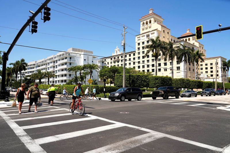 Palm Beach parking enforcement employees direct confused drivers at the intersection of Sunset Avenue and Bradley Place on March 24 after a new traffic signal was activated that morning. Sunset Avenue is also now a two-way street instead of being eastbound-only.