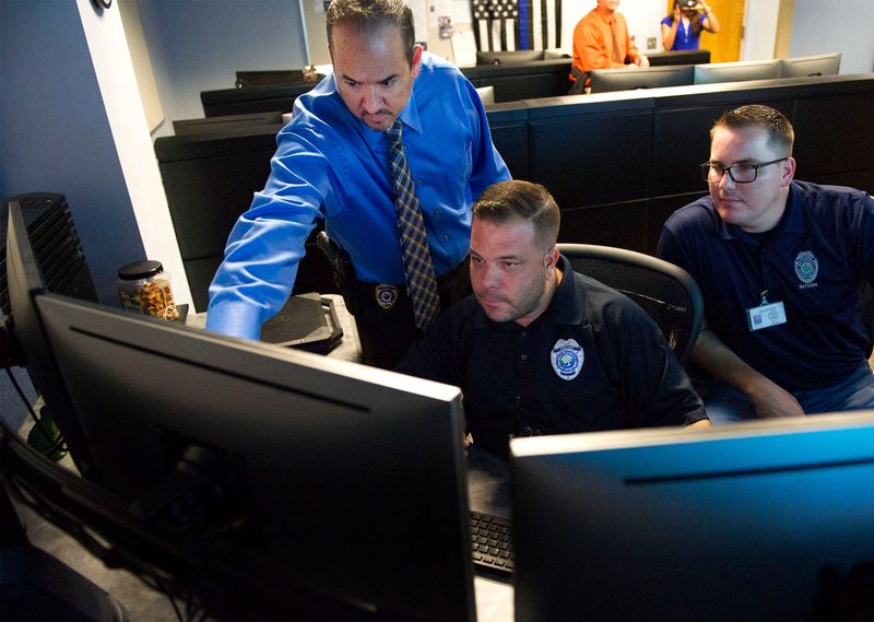 Police officials in West Palm Beach police's Real-Time Crime Center examine video footage in 2018.