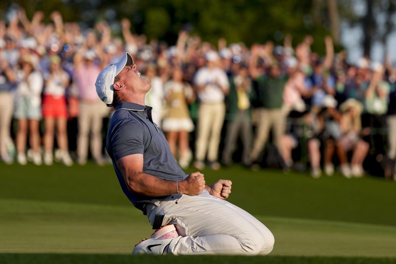 Apr 13, 2025; Augusta, Georgia, USA; Rory McIlroy falls to his knees in celebration after winning a playoff on the no. 18 green during the final round of the Masters Tournament at Augusta National Golf Club. Mandatory Credit: Kyle Terada-Imagn Images