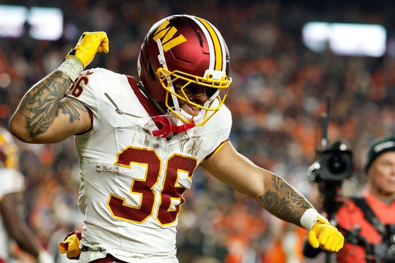 Nov 30, 2025; Landover, Maryland, USA; Washington Commanders running back Chris Rodriguez Jr. (36) celebrates after scoring a touchdown against the Denver Broncos in the second quarter at Northwest Stadium. Mandatory Credit: Geoff Burke-Imagn Images