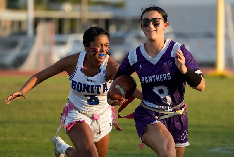 Cypress Lake player Addison Apicella is chased down by Bonita Springs defender Isabella Martinez. The Bonita Springs High School girls flag football team faced off against Cypress Lake High School Thursday, March 26, 2026. Bonita Springs came away with the win with a final score 21-0.