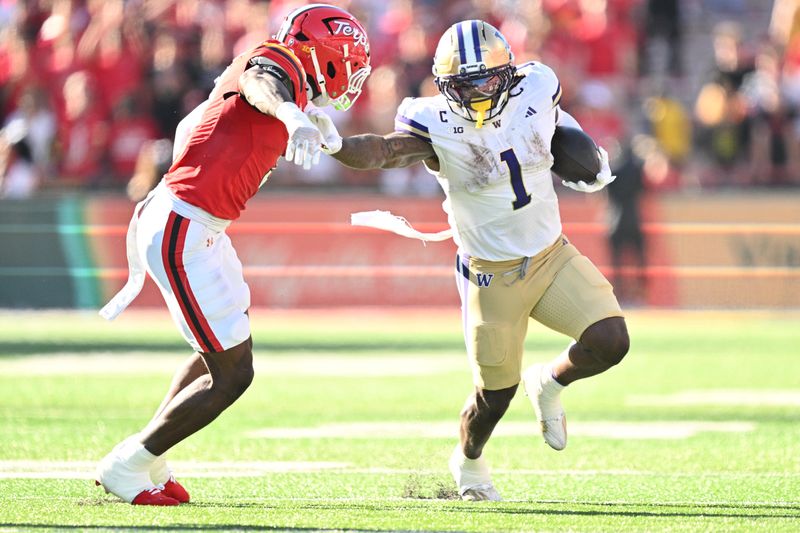 Oct 4, 2025; College Park, Maryland, USA; Washington Huskies running back Jonah Coleman (1) stiff arms Maryland Terrapins linebacker Trey Reddick (3) while picking up yardage in the first half at SECU Stadium. Mandatory Credit: Jamie Sabau-Imagn Images