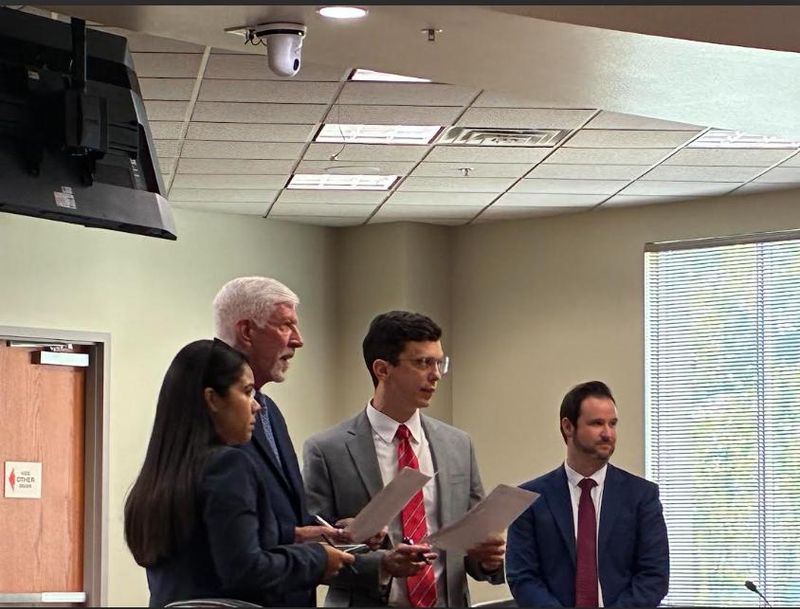 The defense and prosecutors huddled to talk about potential jurors in the Justin Jacob Cobb trial on March 30, 2026.