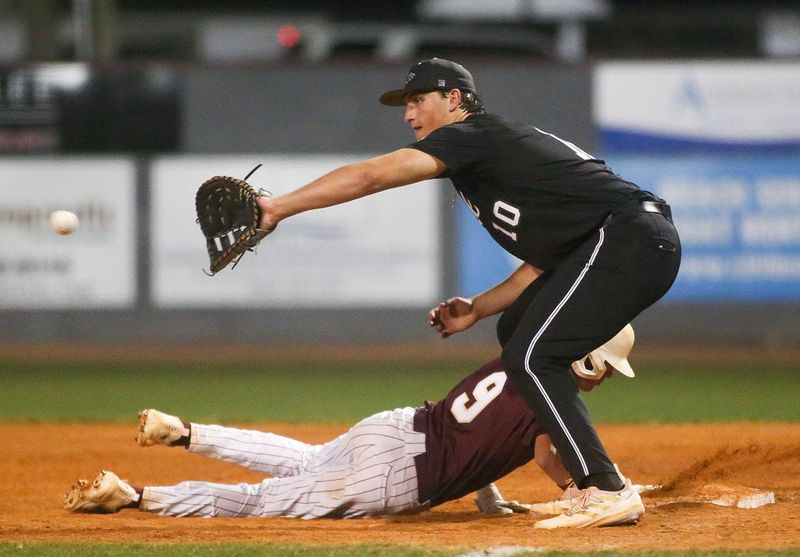 Niceville’s Ethan Thomas dives back to first as South Walton’s Coleman Borthwick reaches for the ball during the Niceville South Walton baseball game at Niceville.