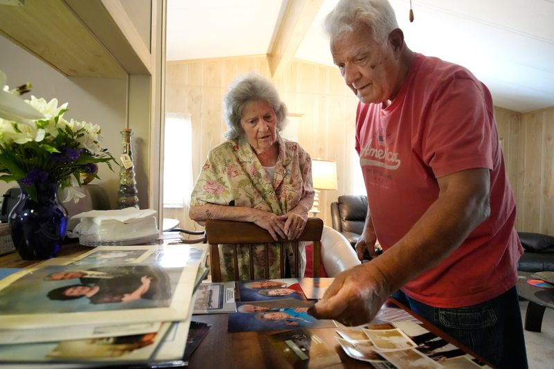 Paul and Marie Laramee sort through old photographs in their Sarasota home while looking for wedding photos for this story.