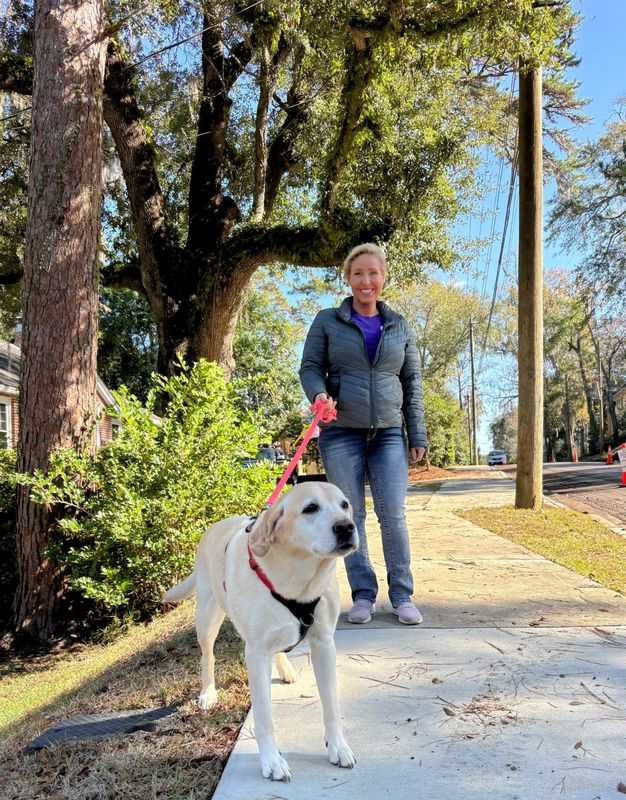 Angela Mageau of Tallahassee Lassie Pet Care walks Daisy in Midtown.