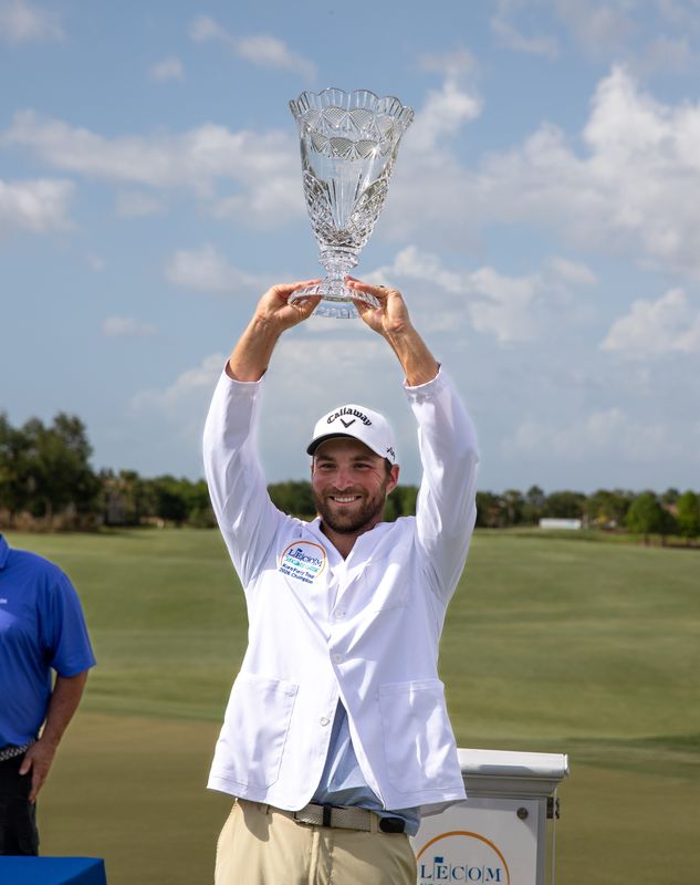 Jeremy Gandon raises the 2026 LECOM Suncoast Classic winner's trophy at Lakewood National Golf Club on Sunday, April 5, 2026.