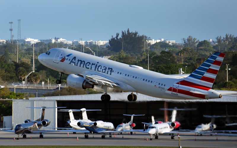 An American Airlines jet takes off past private jets at Palm Beach International Airport on March 11, 2026, in West Palm Beach, Florida.