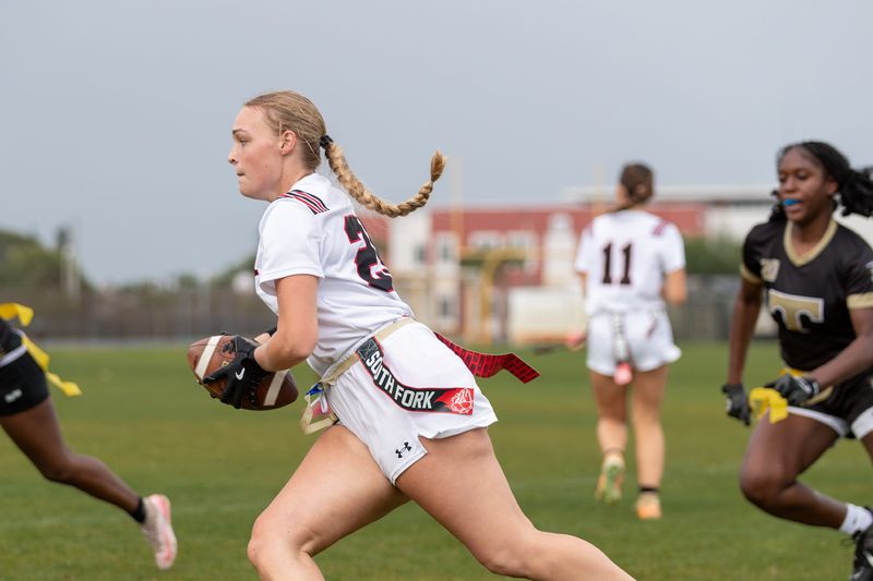 South Fork’s Cadence Reed (25) runs the ball upfield during a high school flag football game on April 2, 2026, at Treasure Coast High School in Port St. Lucie. The game was postponed shortly before halftime due to lightning.