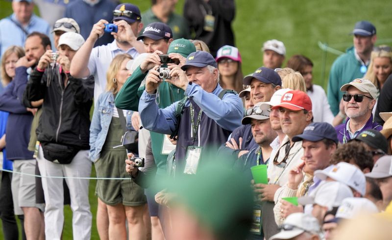 Apr 7, 2026; Augusta, Georgia, USA; Patrons watch Rory McIlroy on no. 6 during a practice round for the Masters Tournament at Augusta National Golf Club. Mandatory Credit: Katie Goodale-Imagn Images
