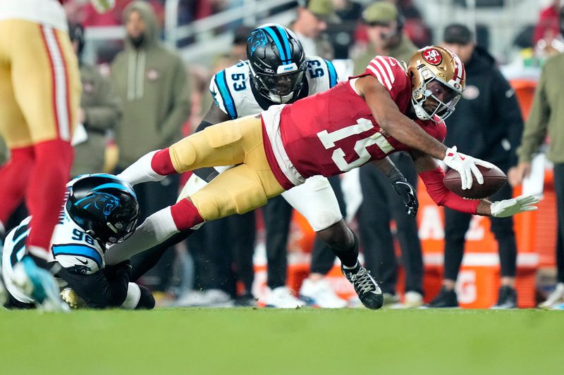 Nov 24, 2025; Santa Clara, California, USA; San Francisco 49ers wide receiver Jauan Jennings (15) makes a catch against Carolina Panthers linebacker Claudin Cherelus (53) during the first half at Levi's Stadium. Mandatory Credit: Kyle Terada-Imagn Images