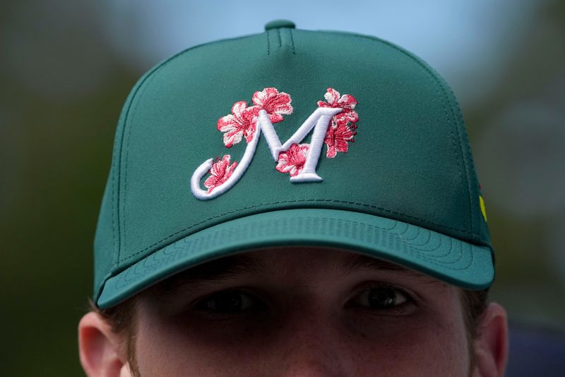 Apr 7, 2026; Augusta, Georgia, USA; A patron wears a Masters hat featuring the letter “M” adorned in azaleas during a practice round for the Masters Tournament at Augusta National Golf Club. Mandatory Credit: Michael Madrid-Imagn Images