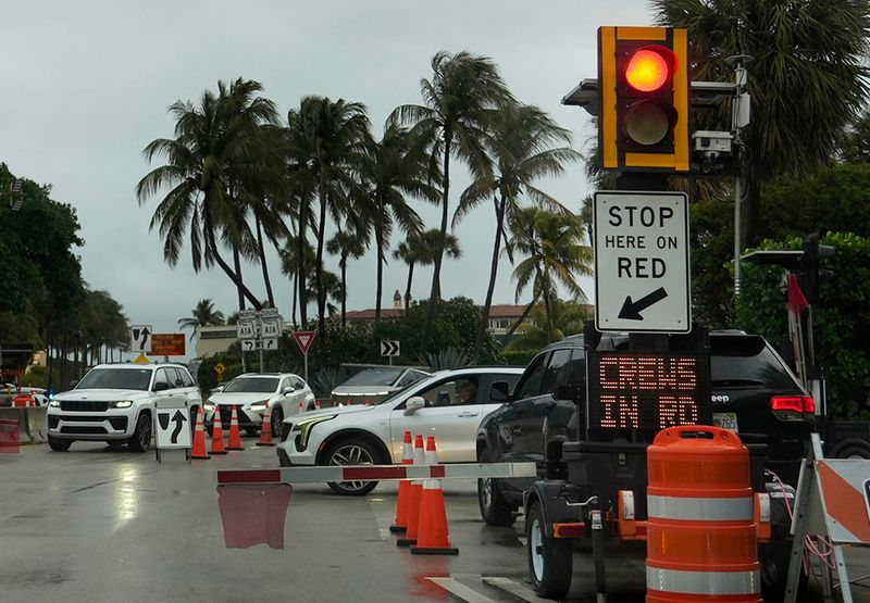 A signal halts traffic along Southern Boulevard near President Donald Trump's Mar-a-Lago Club in Palm Beach on April 7. The signals were activated on Oct. 13 "as part of law enforcement activity," a spokesperson for the Florida Department of Transportation said.