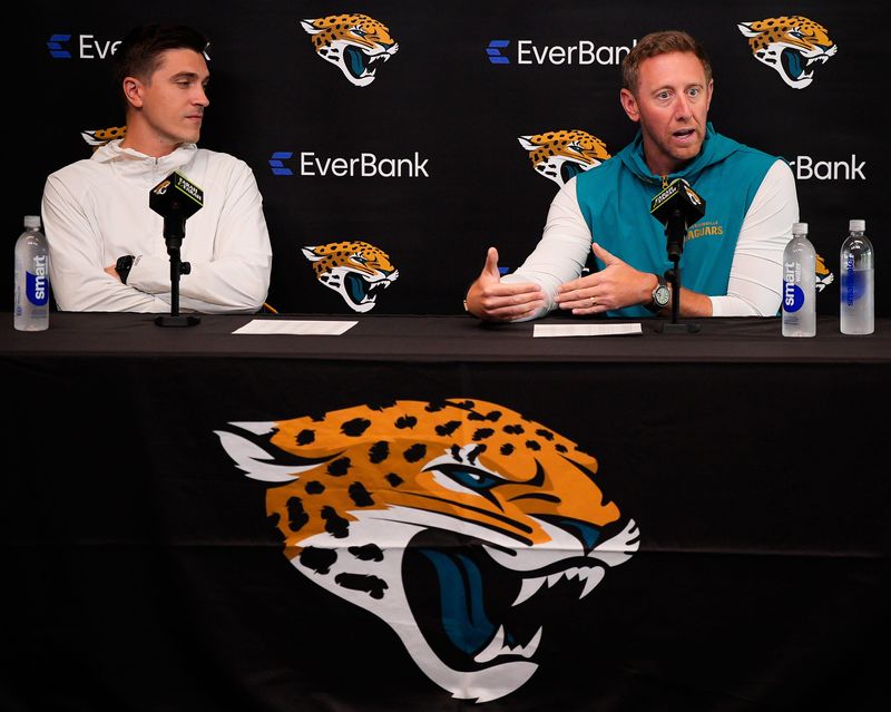 Jaguars General Manager James Gladstone, left listens as head coach Liam Coen talks about the upcoming NFL draft during the Jacksonville Jaguars’ annual pre-draft luncheon press conference in the media room at the Miller Electric Center Thursday April 9, 2026 in Jacksonville, Fla. [Doug Engle/Florida Times-Union]