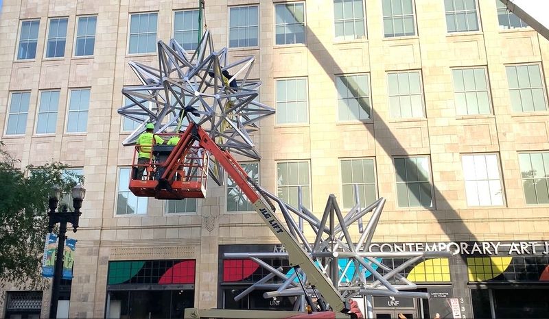 The Museum of Contemporary Arts Jacksonville installed a sculpture titled "Jacksonville Stacked Stars" on the Laura Street sidewalk in front of the museum entrance in downtown Jacksonville. A crew of workers used a crane to put the top half of the sculpture in place on April 9, 2026. Famed artist Frank Stella created "Jacksonville Stacked Stars" that was his last major work before he died in 2024.