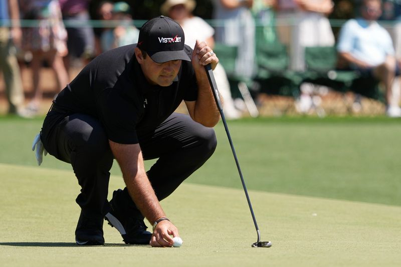 Apr 10, 2026; Augusta, Georgia, USA; Patrick Reed lines up a putt on the first green during the second round of the Masters Tournament at Augusta National Golf Club. Mandatory Credit: Michael Madrid-Imagn Images